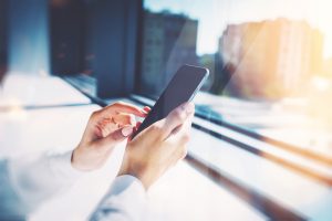 Girl touching a screen of her smarthone